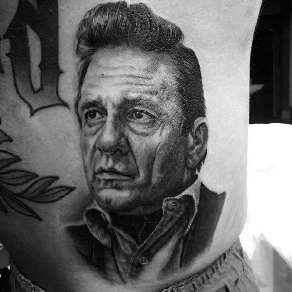 Realistic black and grey portrait tattoo of Johnny Cash, featuring his intense gaze and iconic hairstyle