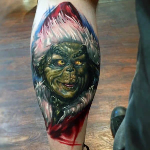 Vivid Grinch face in a red Santa hat, with dramatic shading and vibrant colors, capturing his mischievous expression in a dynamic and bold tattoo design.