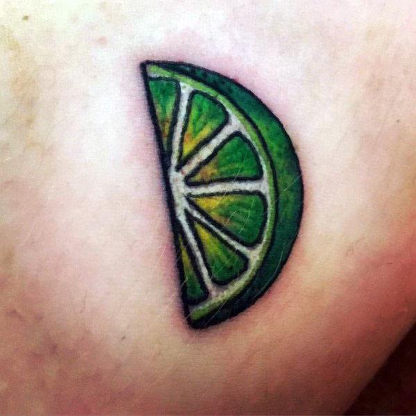 Small lime wedge tattoo with bold green and yellow shading, featuring a thick black outline for a vibrant and crisp citrus-inspired design.