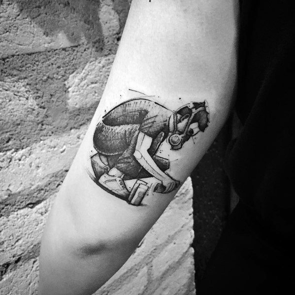 Black and gray sketch-style tattoo of the Linkin Park gas mask figure, featuring intricate shading and a rough, hand-drawn aesthetic.