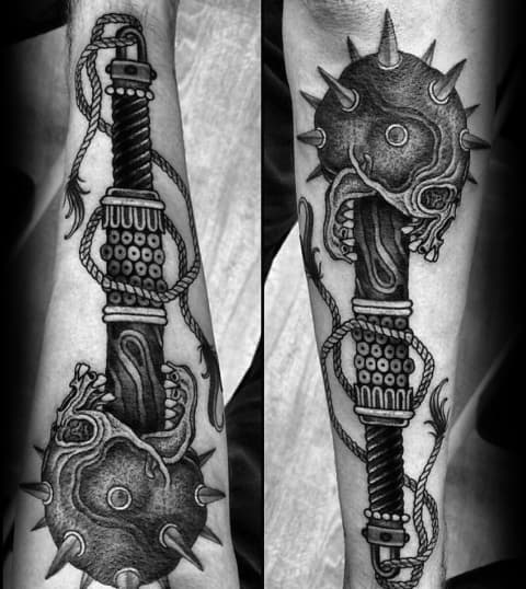 Intricate black and gray mace tattoo featuring spiked skull details, a textured handle, and coiled rope, symbolizing strength, battle, and resilience.