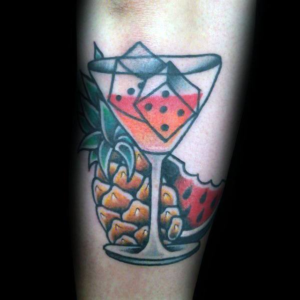 Colorful martini glass tattoo with tropical elements, featuring pineapple, watermelon, and dice-shaped ice cubes. A bold and vibrant summer-inspired design.