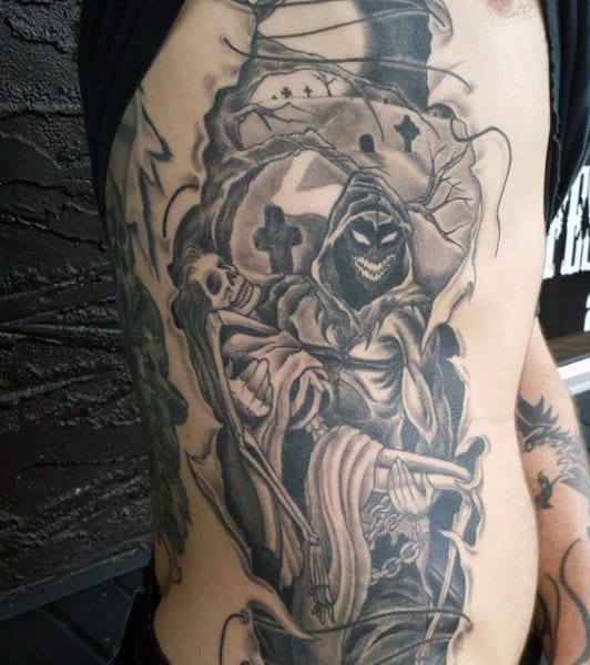 Black and grey Grim Reaper with a scythe in front of a graveyard on side torso