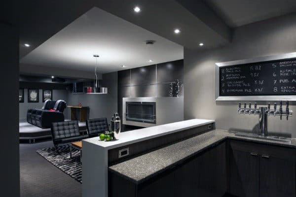 masculine mens modern basement man cave wet bar with taps black lounge chairs fireplace 