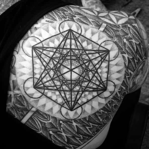 Shoulder tattoo of Metatron’s Cube over layered dotwork and tribal-style geometry, creating a bold and textured sacred design.