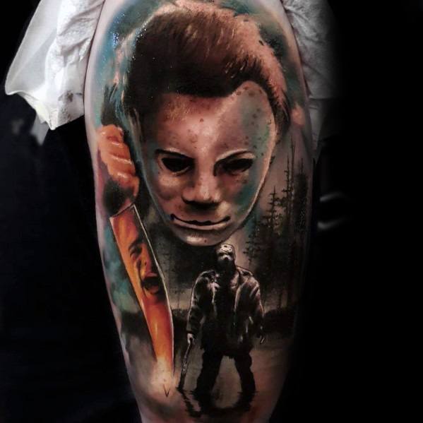 Hyper-realistic Michael Myers tattoo featuring his eerie mask, a bloody knife, and a shadowy figure in a dark forest setting.
