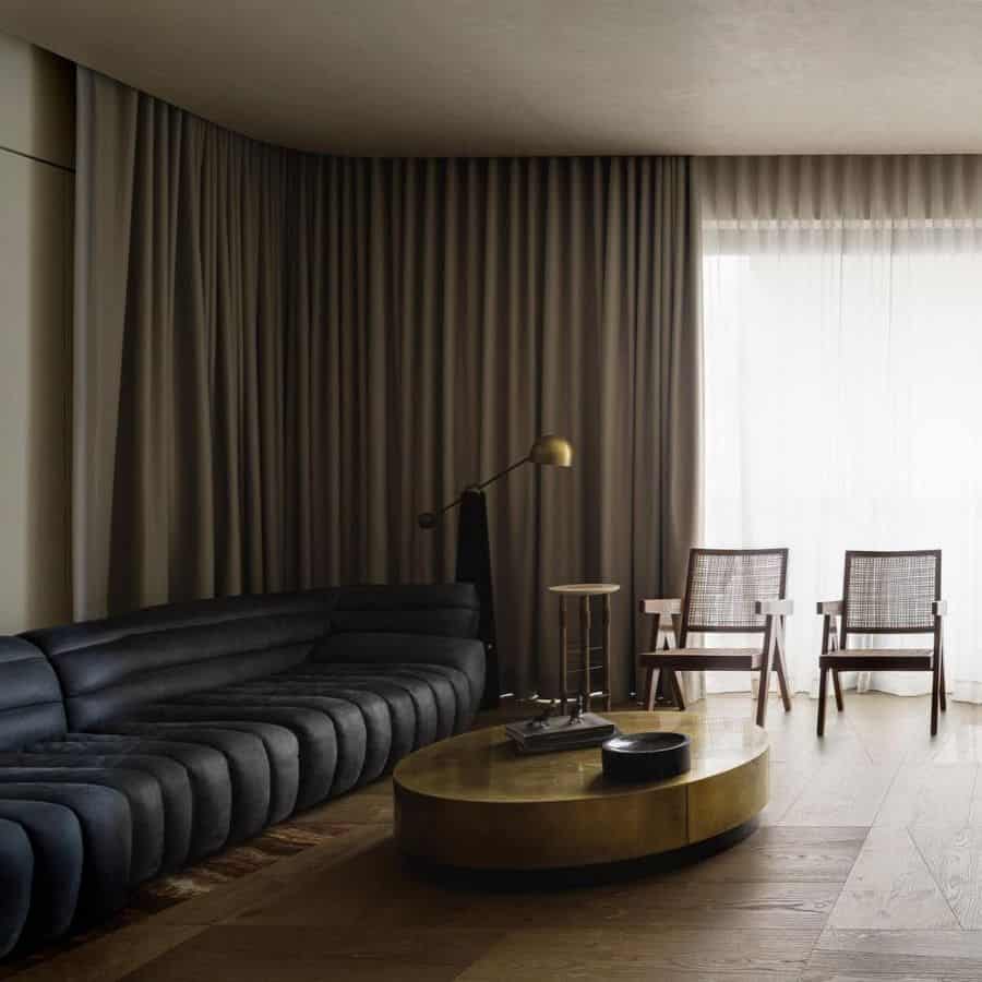 dark masculine living room with black sofa 