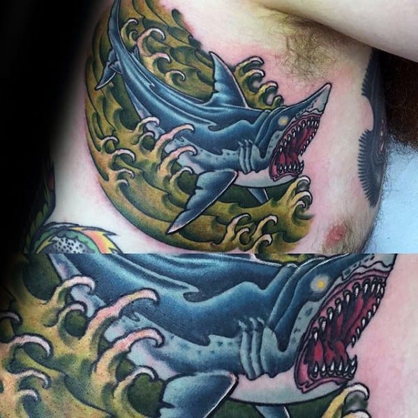 Neo-traditional shark tattoo on the ribs with vivid green waves, bold black shading, and a fierce open-jaw expression.