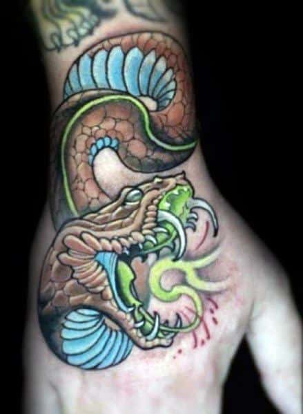 Neo-traditional tattoo of a fierce brown snake with blue and green accents, fangs bared and venom dripping, creating a bold and dynamic design.