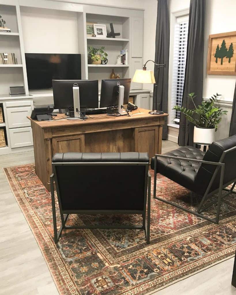 large home office elegant wood desk black accent chairs built-in wall shelves and cabinets