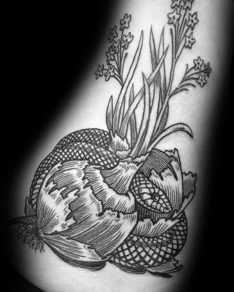 Black and grey onion tattoo with fine line details, featuring textured shading, sprouting leaves, and delicate flowers for a botanical-inspired design.