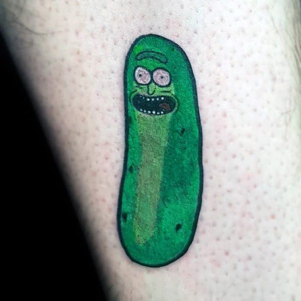 Minimalist Pickle Rick tattoo with a simple cartoon-style design, bold outlines, and subtle shading on the arm.
