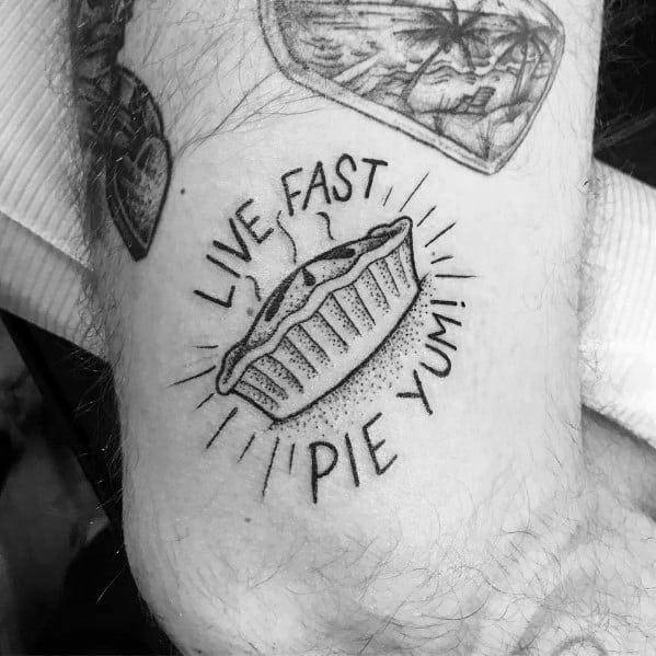 Black and white pie tattoo with the phrase “Live Fast, Pie Yum!” featuring a simple, bold design with a fun and playful vibe