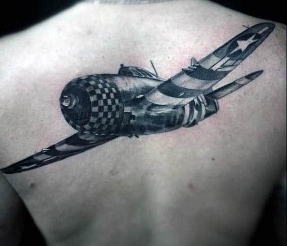 A detailed tattoo of a vintage fighter plane on a person's back
