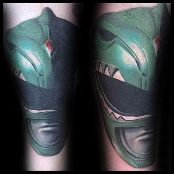 Realistic Green Ranger helmet tattoo with smooth shading, metallic green tones, and subtle highlights wrapping around the forearm.