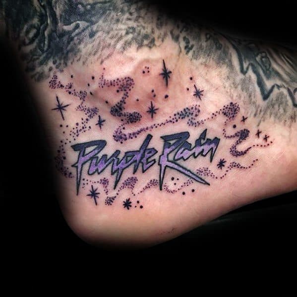 Tattoo of "Purple Rain" with purple dots and stars on an ankle, a tribute to Prince