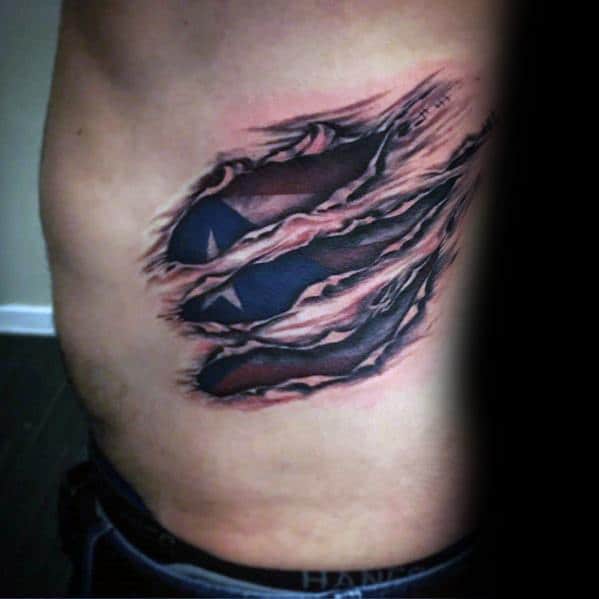 Puerto Rican flag tattoo with a ripped skin effect on the ribs, revealing bold red, white, and blue colors with a striking star design.