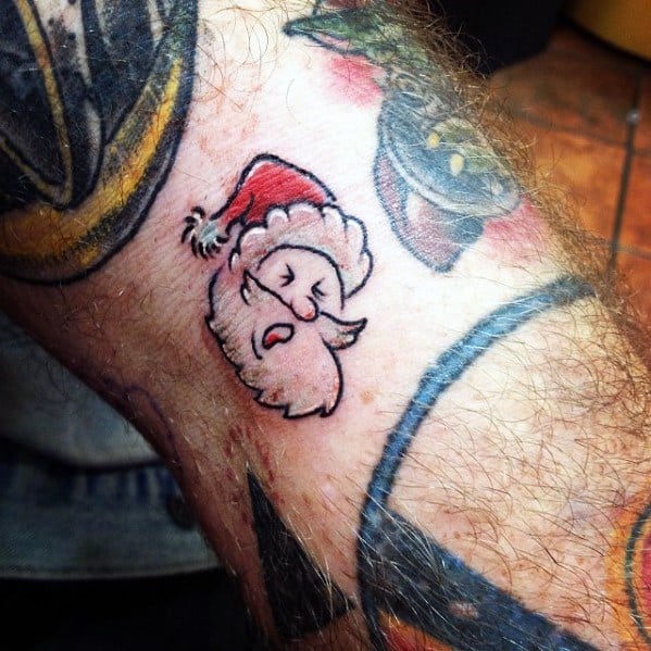 Minimalist Santa Claus tattoo with a cute and playful expression, featuring bold outlines and simple details for a fun and festive look.