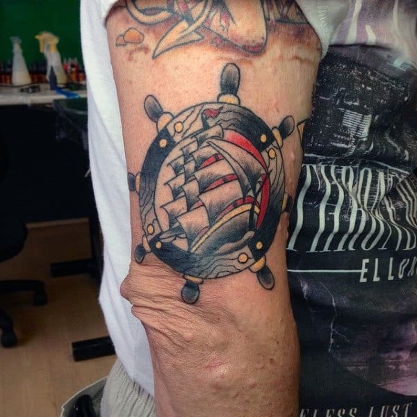 Masculine Ship Wheel With Sailing Ship Design On Mans Arm