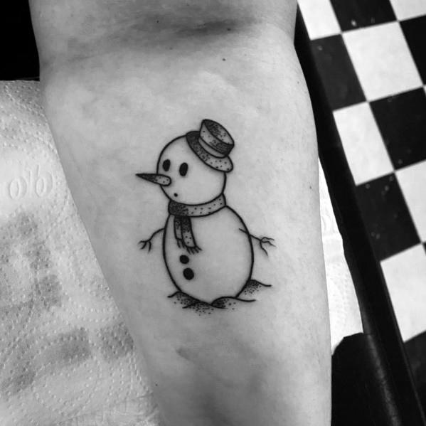 Simple and charming black ink snowman tattoo with a top hat, scarf, and twig arms, capturing a classic winter look with delicate details.