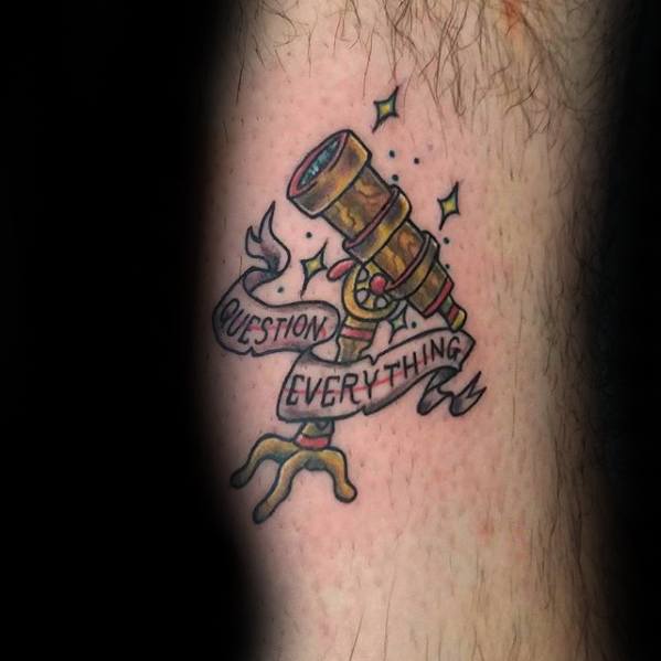 Telescope tattoo wrapped with a "Question Everything" banner