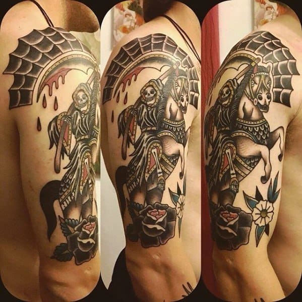 Traditional upper arm tattoo of a skeleton reaper on horseback, holding a scythe under a webbed arch with roses and bold color shading.