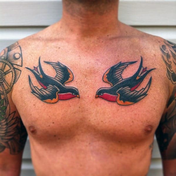 Man with swallow bird tattoos on his chest