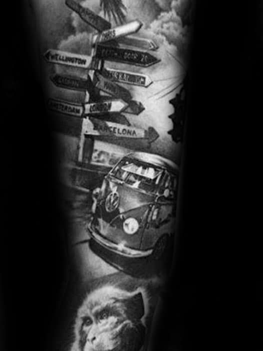 Detailed black and gray tattoo featuring a Volkswagen van, multiple city signposts, and a monkey portrait, symbolizing travel and adventure.