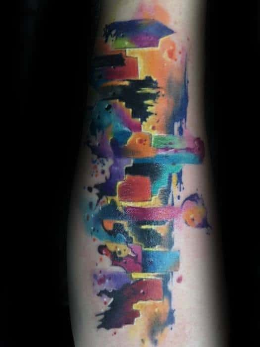 Dallas skyline tattoo in a vivid watercolor style, blending bold shades of orange, blue, purple, and pink for a striking abstract look.