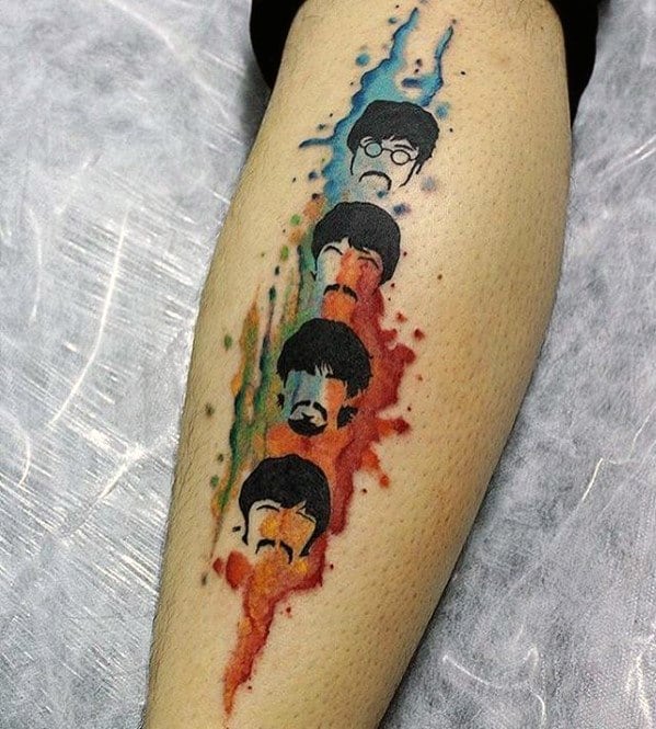 Colorful watercolor-style tattoo of The Beatles' faces stacked vertically, each outlined with minimal features and vibrant paint splashes behind them.