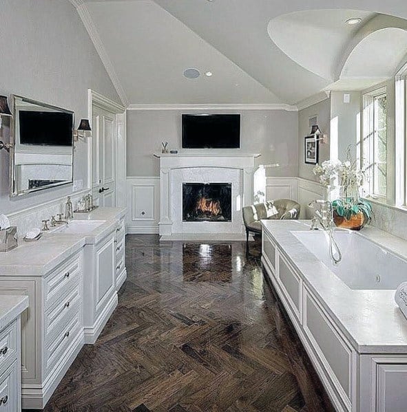 elegant white master bathroom with fireplace