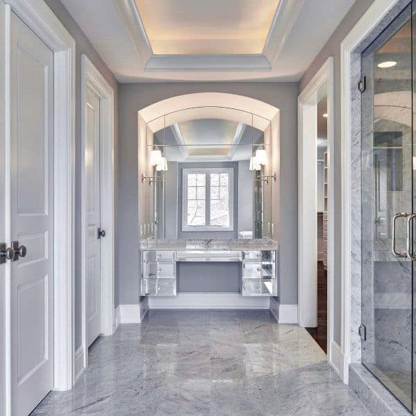 Elegant master bathroom with crown molding lighting, creating a luxurious atmosphere around the marble fixtures