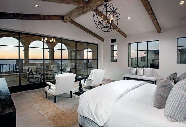 luxury master bedroom with balcony and ocean views