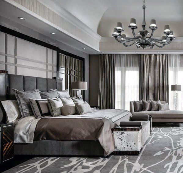 Elegant master bedroom featuring crown molding, plush bedding, a luxurious chandelier, and floor-to-ceiling windows with drapes