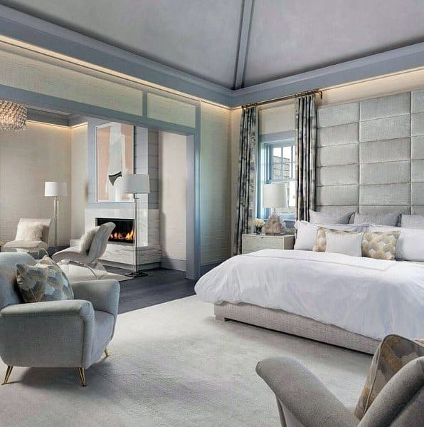 elegant master bedroom with stone fireplace 