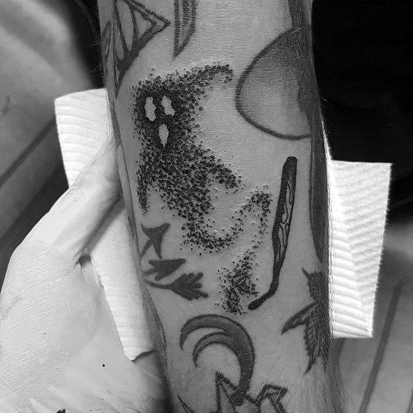 Blackwork tattoo of a ghostly figure formed by smoke above a burnt matchstick, blending spooky vibes with symbolic burnout or transformation.