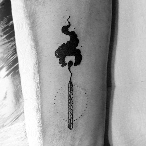 Blackwork tattoo of a burning matchstick with bold rising smoke and dotted circle detail, symbolizing focus, energy, and transformation.