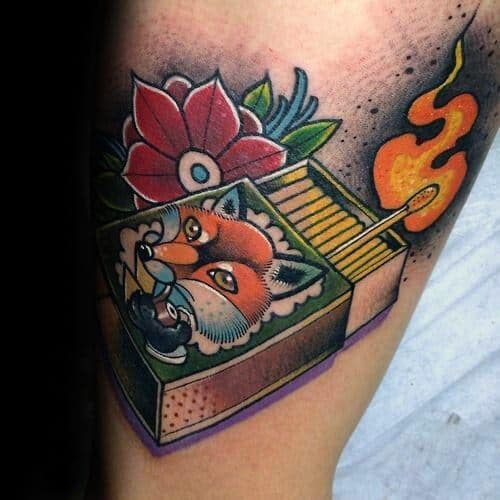 Colorful neo-traditional tattoo of a matchbox with a fox, flower, and lit match, symbolizing cleverness, beauty, and fiery spirit.