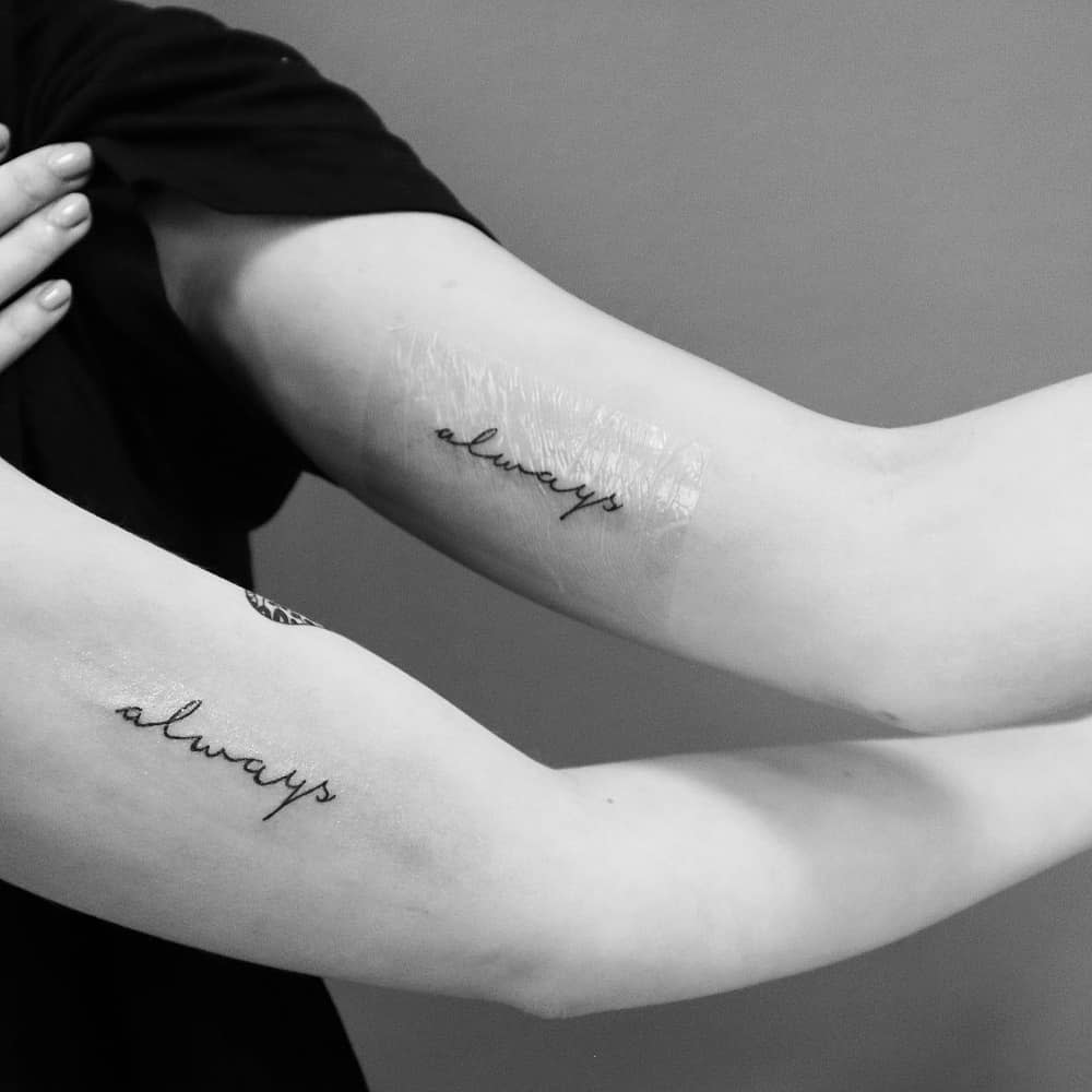 Two forearms, each with the word "always" tattooed in cursive script