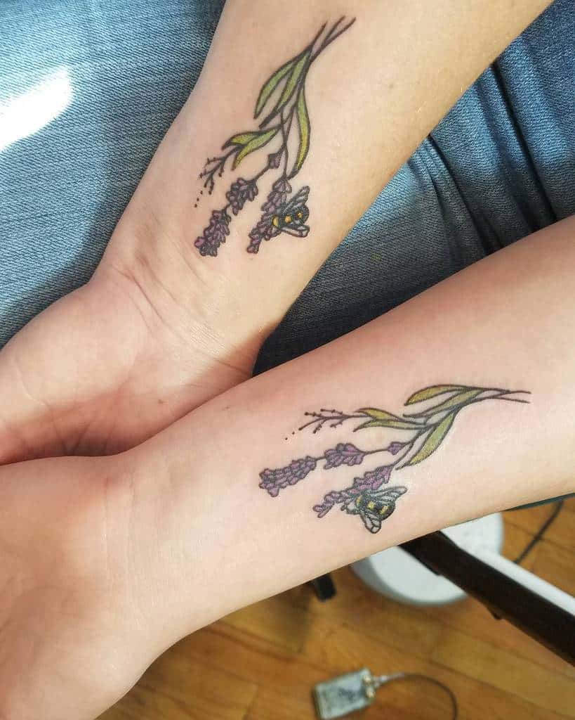 Matching mother-daughter tattoos of lavender sprigs with a bee, symbolizing love, growth