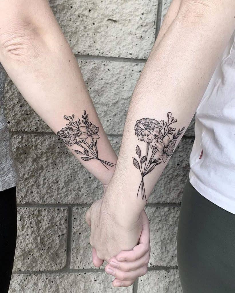 A beautiful matching tattoo of two floral bouquets on each arm, with intricate linework and delicate details, symbolizing a shared connection.