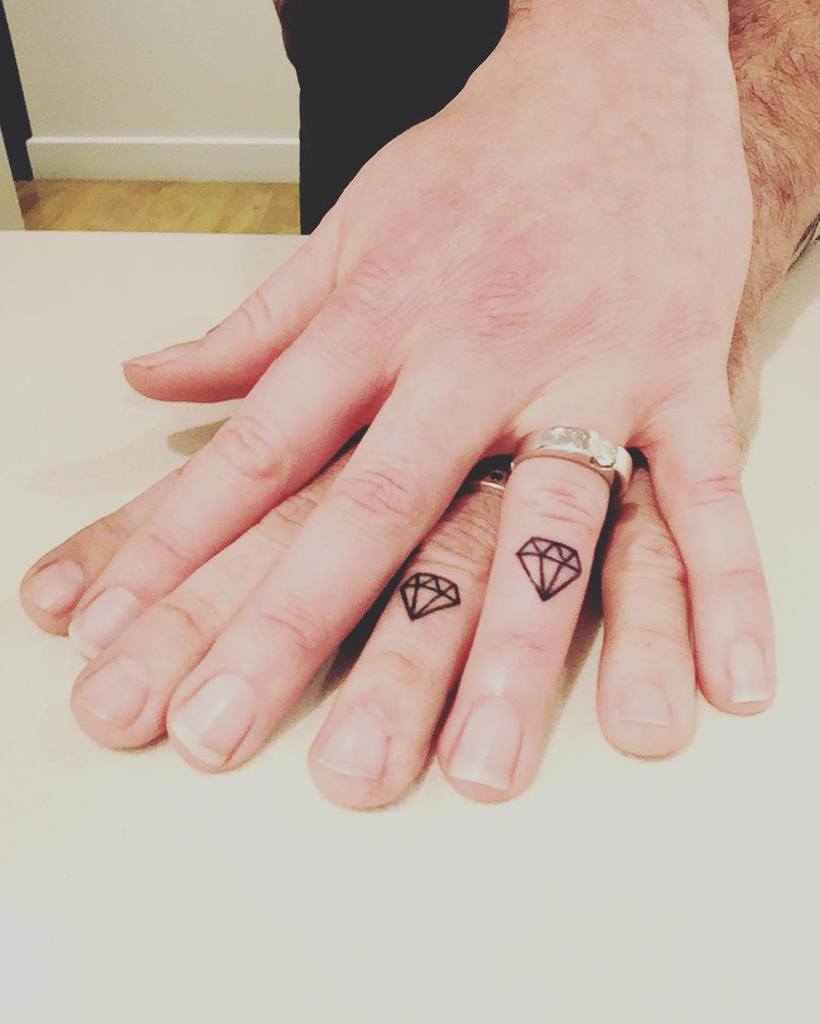 Matching wedding ring tattoos of diamonds, symbolizing strength and commitment