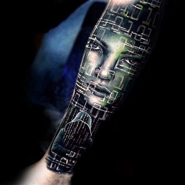 Forearm tattoo featuring a woman's face intertwined with binary numbers and a hooded figure looking at a screen