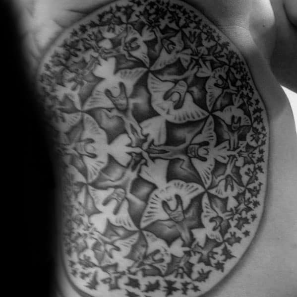 MC Escher-inspired side tattoo featuring a radial tessellation of angels and devils, blending into geometric repetition across the torso.
