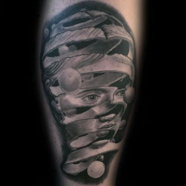 Surreal tattoo inspired by MC Escher and Dali, featuring a floating ribbon forming a woman's face with 3D spheres orbiting around it.