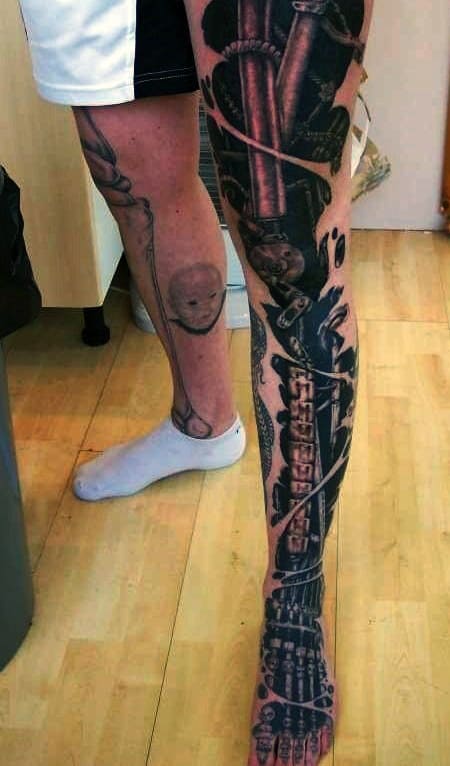 Biomechanical and skeletal tattoo on a leg