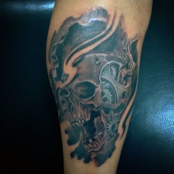 Tattoo of a mechanical skull with gears and smoke on an arm