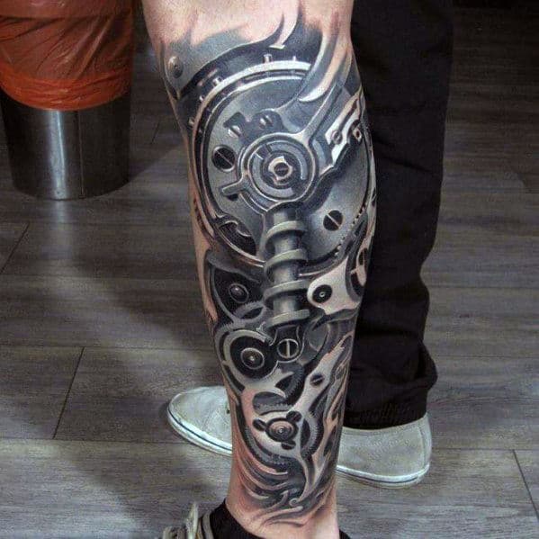 A leg tattoo with intricate biomechanical design in black and grey ink