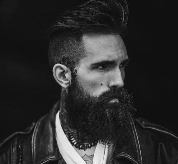 Man with styled, voluminous hair and a long beard