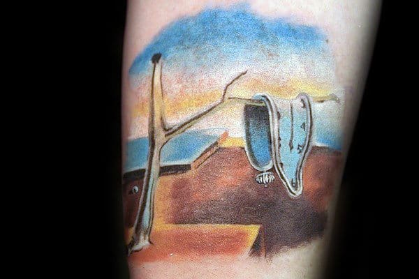 Tattoo of Dali's melting clock draped over a bare tree branch with a painted background